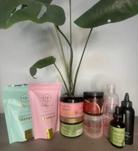 A variety of natural hair care products next to each other. The brands include Curly Proverbz, Camille Rose, Kinky Curly, As I Am, Mielle Organics and Sunday II Sunday.